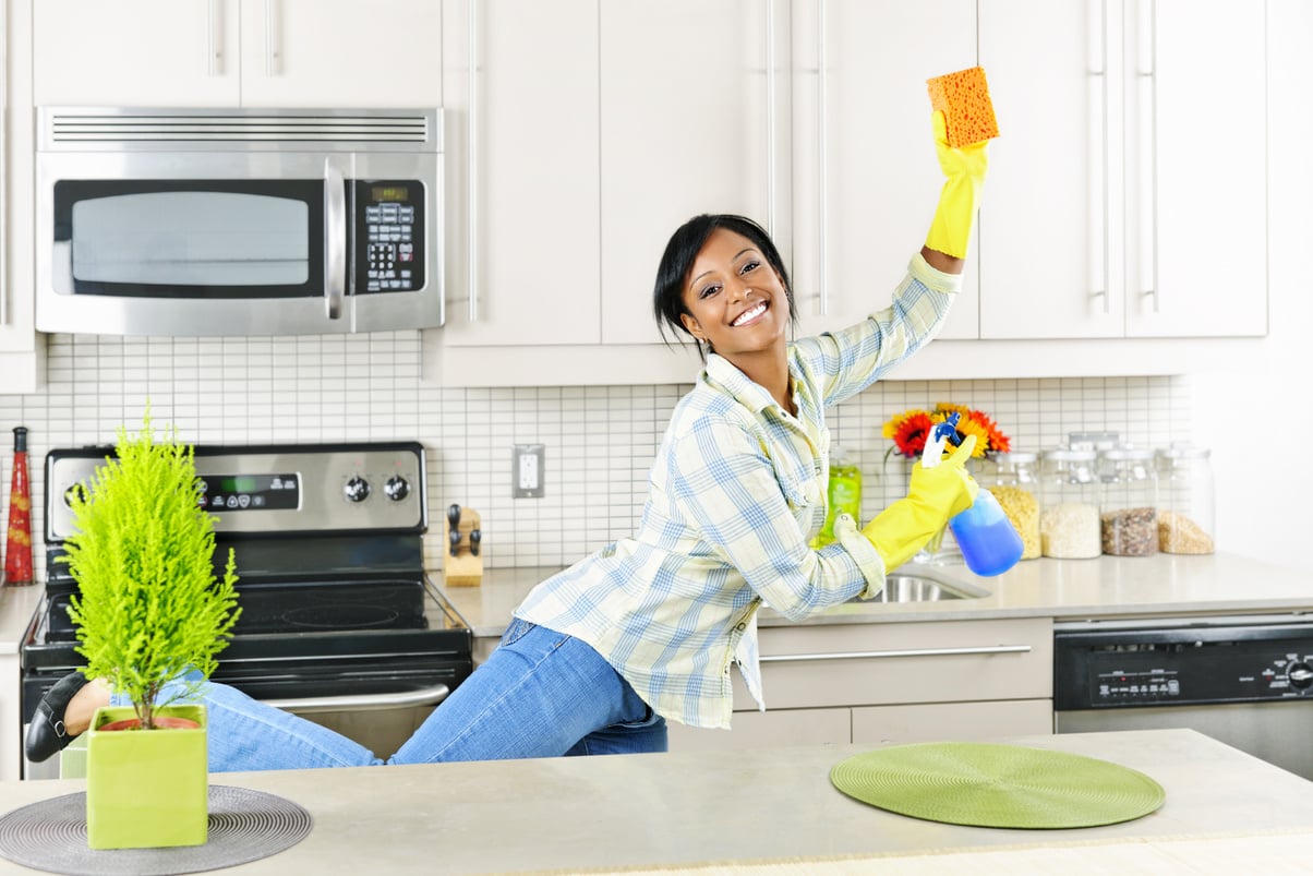 Young Woman Cleaning Kitchen